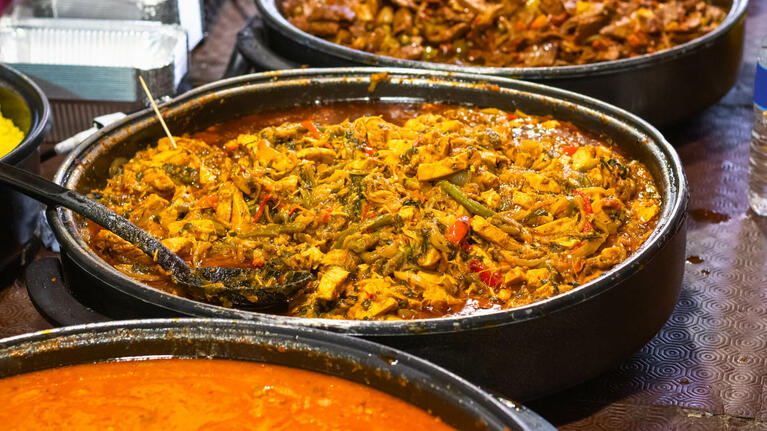 Large dishes of curry in London's Brick Lane