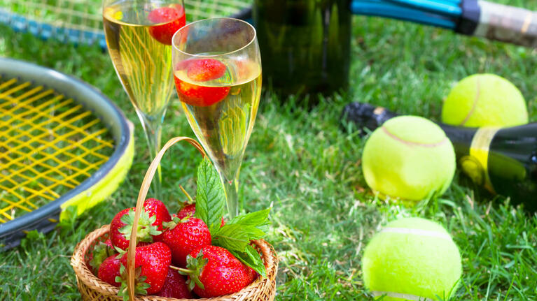 People enjoying a class of champagne at the Wimbledon Championships